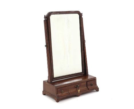 An early George III mahogany dressing mirror,18th century, the mirror support with acorn finials, over three drawers, raised 