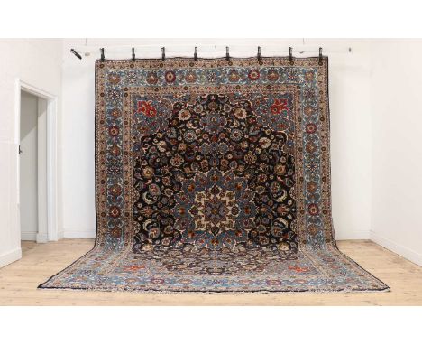 A Meshed carpet,of recent manufacture, with a a large central medallion, to a navy ground and blue borders,379 x 291cmConditi