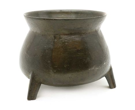 A bronze cauldron,18th century, with a flared rim, on three legs,18cm diameter Provenance: The Estate of Mrs Althea Lloyd.Con