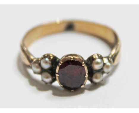 A yellow metal purple half cut pearl and ruby coloured stone ring, unmarked, gross wt. 2.1g, size M.