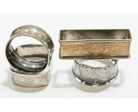 Three hallmarked silver napkin rings and another marked 'Sterling'.