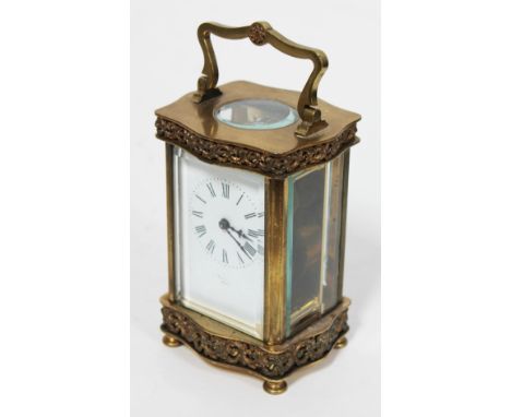 A French brass carriage clock, height 16.5cm.Condition: Wear to brass and dial, name rubbed.  It winds up and is ticking.