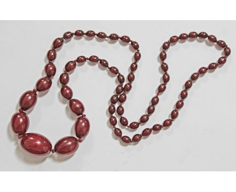A string of vintage cherry amber bakelite beads, length 80cm, gross wt. 53.3g.