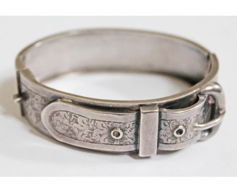 A Victorian white metal bangle formed as a belt buckle marked 'STG', diam. approx. 5.5cm.