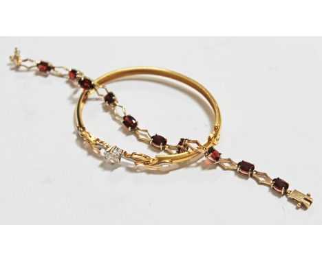 A yellow metal and garnet coloured stone bracelet wt. 7.2g and a gold plated bangle.