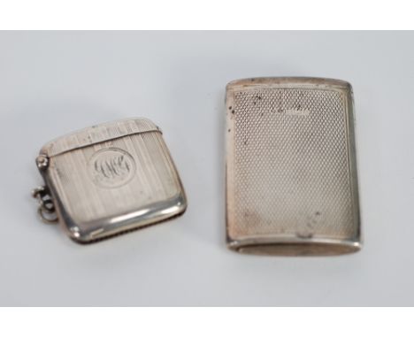 TWO ENGINE TURNED SILVER VESTA CASES, one of typical form, initialled Chester 1915, the other of larger elliptical form with 