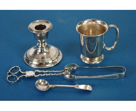 AN INTER-WAR YEARS WEIGHTED SILVER SWARF CANDLESTICK, London 1925, a SILVER CHRISTENING MUG, Sheffield 1940, a PAIR OF GEORGE