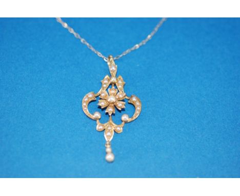 EDWARDIAN 15ct GOLD AND SEED PEARL PENDANT, of openwork scroll pattern with floral centre and small pendant, the whole set wi