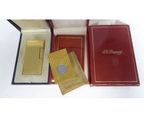 CARAN D'ACHE, GENEVE, SWISS GOLD PLATED PATENT POCKET CIGARETTE LIGHTER, in reeded book shape case, in original gilt blue mor