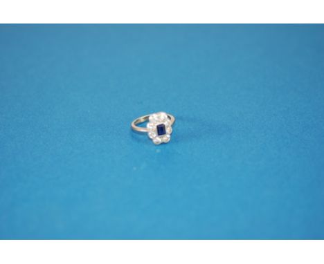 18ct WHITE GOLD, SAPPHIRE AND DIAMOND CLUSTER RING, set with a centre oblong sapphire, approx 5 x 4mm, and surround of eight 