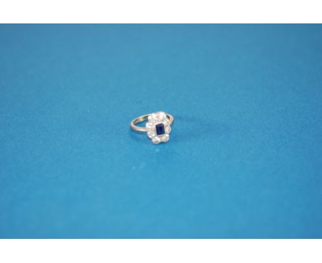 18ct WHITE GOLD, SAPPHIRE AND DIAMOND CLUSTER RING, set with a centre oblong sapphire, approx 5 x 4mm, and surround of eight 