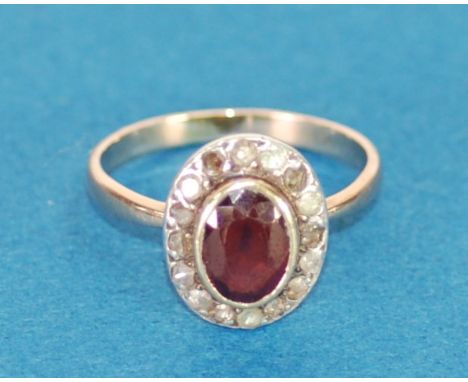 ANTIQUE GOLD COLOURED METAL CLUSTER RING, set with centre oval red stone and surround of sixteen tiny diamonds, 3.2gms, ring 