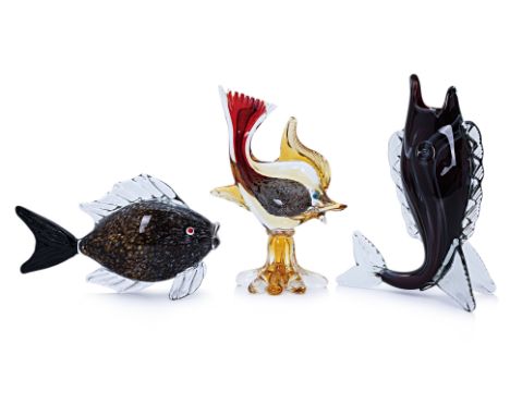 A GROUP OF THREE ART GLASS FISH INCLUDING MURANO
One standing upright on fins, another with interior gold and red tone, on ba