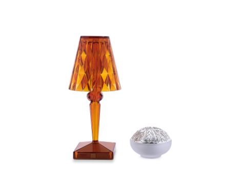 A KARTELL TABLE LAMP AND A CHRISTOFLE TEA LIGHT HOLDER
Italy and France, amber coloured battery table lamp by Ferruccio Lavia