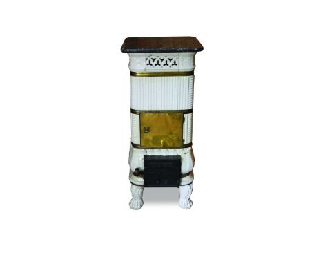 A late 19th/early 20th century Northern European white glazed ceramic and brass mounted square stove with grey veined marble 
