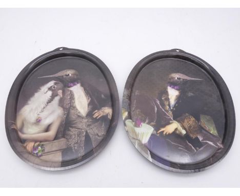 A pair of oval Ibride acrylic trays featuring hummingbirds in 19th century formal dress, one with his pigeon bride. 27x21cm 