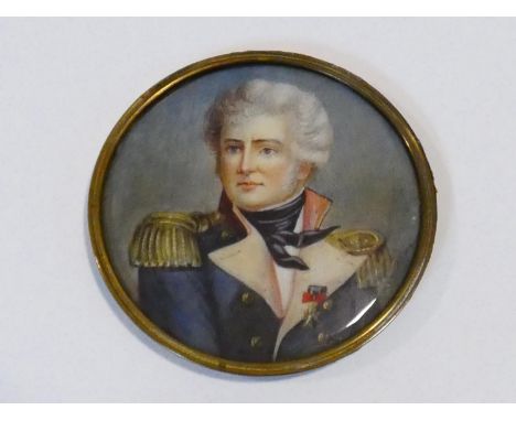 A 19th century signed miniature portrait of a naval officer in uniform, painted on ivory, in gilt metal frame. D.8cm 