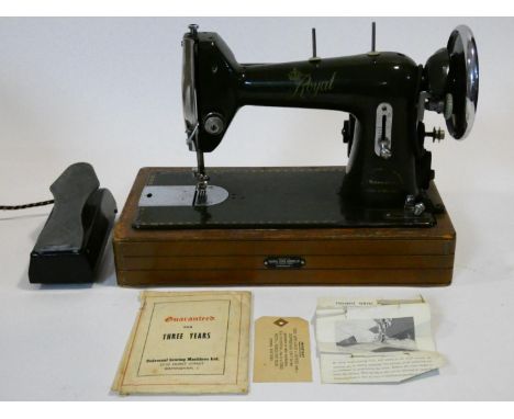 A vintage cased sewing machine with maker's and retailer's labels and with original papers and guarantee. H.30 W.41 D.23cm 