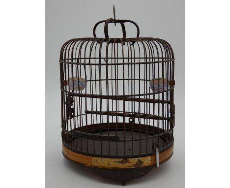 A vintage Oriental wooden bird cage with two ceramic water feeders with cherry blossom design and painted bird and floral des