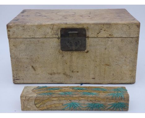 A Chinese lacquered travelling trunk with twin iron carrying handles and a Chinese box with applied coloured soapstone bamboo