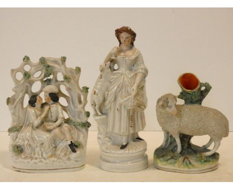 A 19th century Staffordshire flatback figure group, lovers, a 19th century Staffordhire figure of a sheep by a tree trunk and