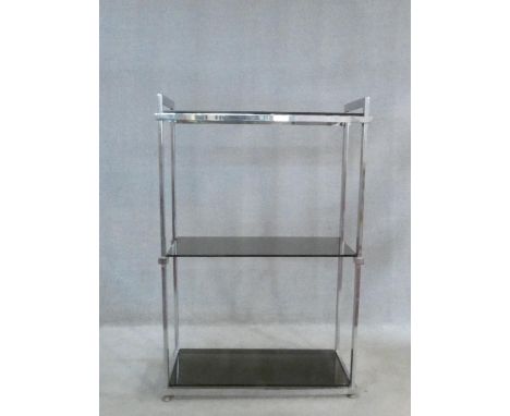 A vintage 1970's three tier etagere with smoked grey glass tiers on a chrome frame. H.124 W.86 D.37cm 