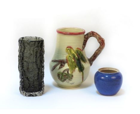 A Clarice Cliff jug, moulded with a parrot, a Moorcroft powder blue vase (no lid), and a Whitefriars vase, tallest 20cm high