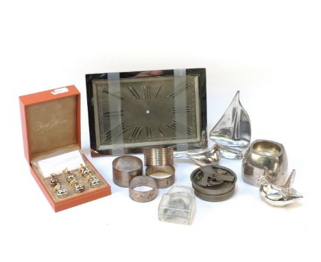 A chrome framed Benson mantel clock, four silver napkin rings, two silver doves and similar