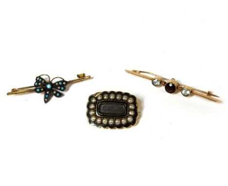 A gold three stone rub set garnet and aquamarine bar brooch, marked 9ct, a Georgian memorial brooch, with woven hair locket t