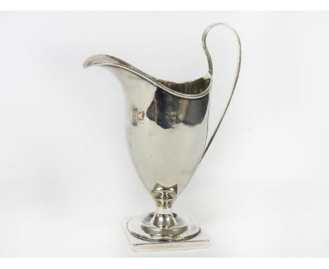 A George III silver helmet shaped cream jug, maker's mark for Nathanial Smith & Co., Sheffield, 1792,14.5cm high