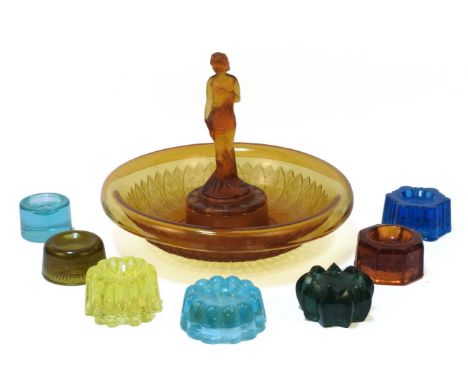 A large quantity of moulded glass furniture stands/tea light holders, coloured and clear, together with a moulded amber glass