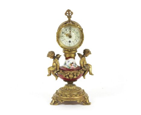 A French gilt metal and porcelain cherub mantel clock. 28cm high