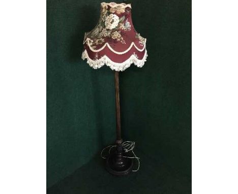 A carved mahogany standard lamp and shade 