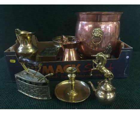 A box containing a quantity of antique brass and copper ware including copper lion mask planter, brass jugs, brass casket etc