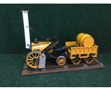 A live steam 'Rocket' engine with coal carriage on stand