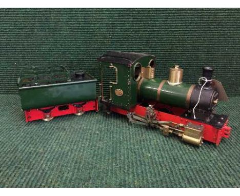 A scratch built model of a steam engine and coal carriage