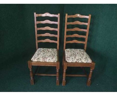 A pair of oak ladder back dining chairs 