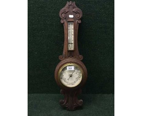 An Edwardian carved mahogany cased barometer 