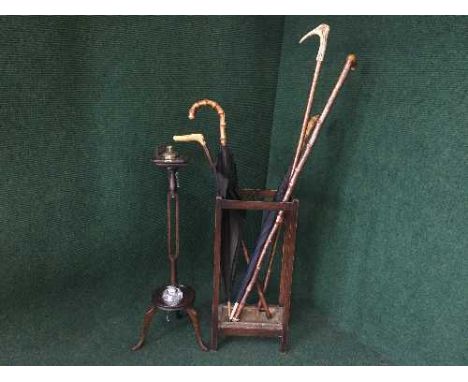 An oak smoker's stand, cut glass table lighter, stick stand with two umbrellas and two walking sticks 