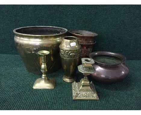 A tray of brass candlesticks, beaten copper bowl, heavy brass planter etc