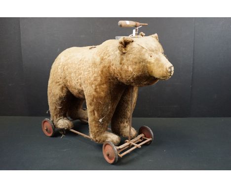 Early-mid 20th C pull along bear, unmarked but in the Steiff style, with hump to shoulders, straw filled, well loved and show