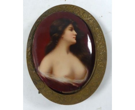 LATE NINETEENTH CENTURY GERMAN HAND PAINTED OVAL PORCELAIN PLAQUE, bust portrait of a scantily clad young woman with long dar