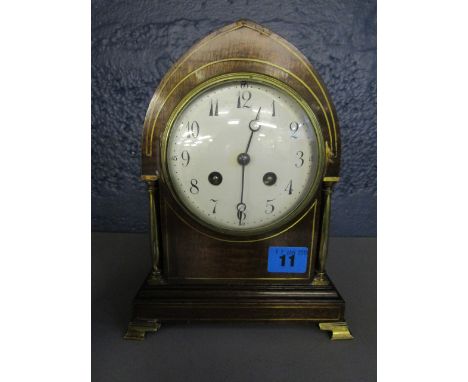 A late Victorian inlaid mahogany mantle clock, the arched case with inlaid brass stringing, with enamelled Arabic dial flanke