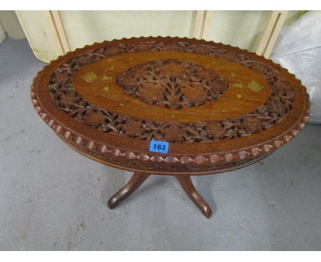 A hardwood occasional table, the oval top with pierced leaf and inlaid metal decoration on a tripod base