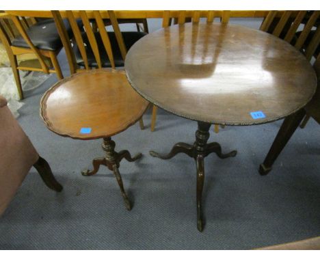 A 19th century mahogany pedestal table, with a circular snap top with a moulded carved edge on a leaf carved pedestal and tri