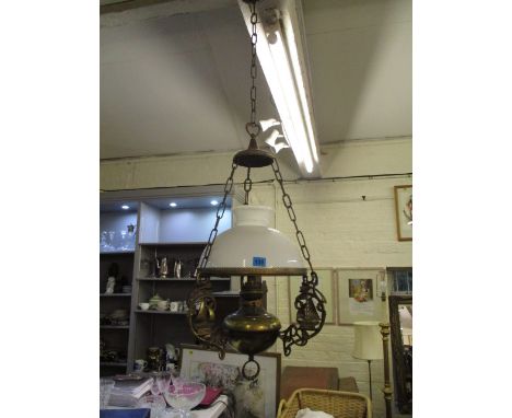An early 29th century brass hanging oil lamp with a white glass shade and boat ornament