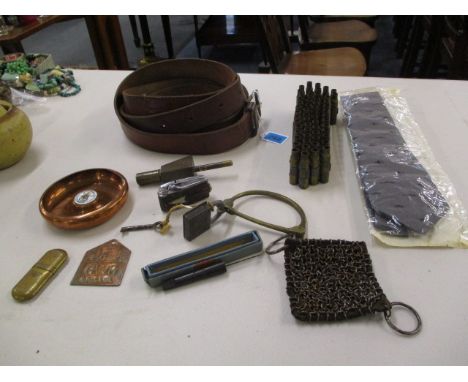 Mixed military items to include a belt, a copper badge, a table lighter and other items