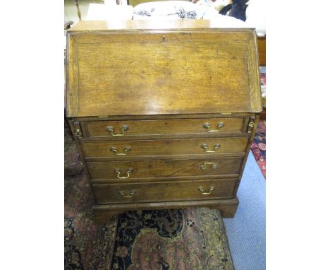 A Georgian four drawer oak bureau raised on bracket feet, 38 h, 30 w