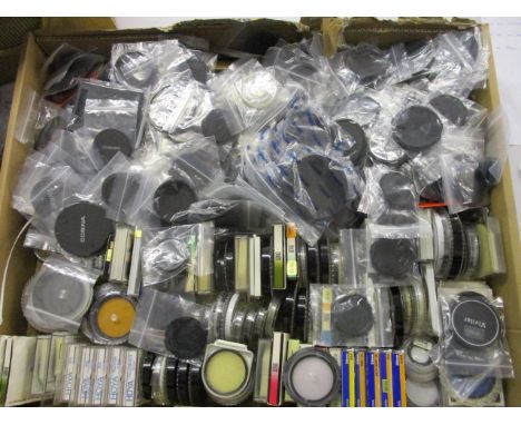 A box of camera lens caps and filters