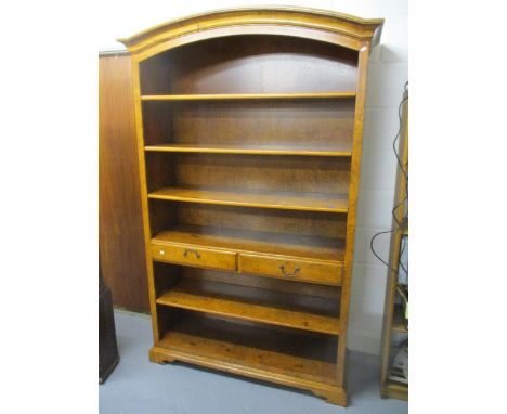 A modern bur elm bookcase with six shelves and two drawers, raised on bracket feet, 81h x 52w